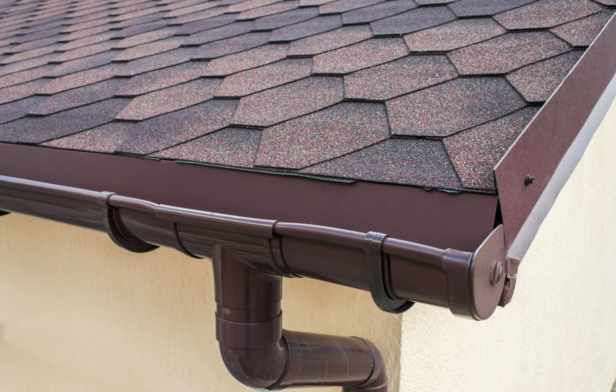 Exterior gutter installation along the roofline